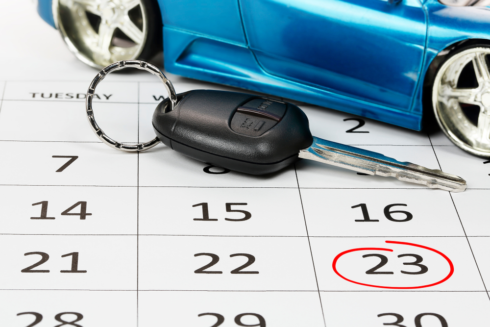 A calendar with car keys on it indicating a month-long rental