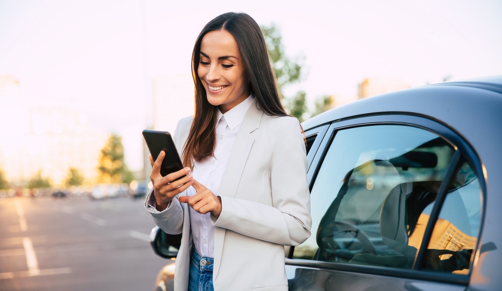 Business traveler smiling in a rental car