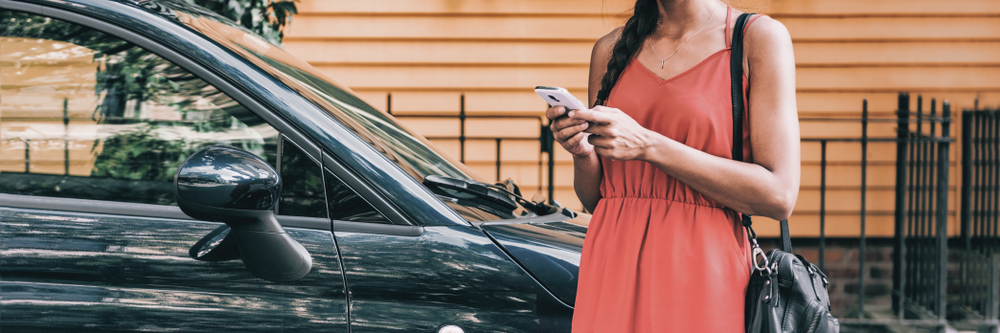 Traveler booking a car using a digital car rental solution.